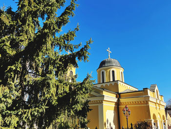 Low angle view of church against blue sky