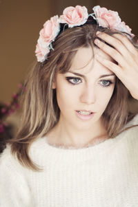 Close-up of beautiful young woman wearing flowers