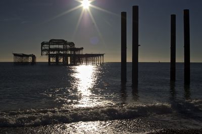 Abandoned palace pier in sea against sky