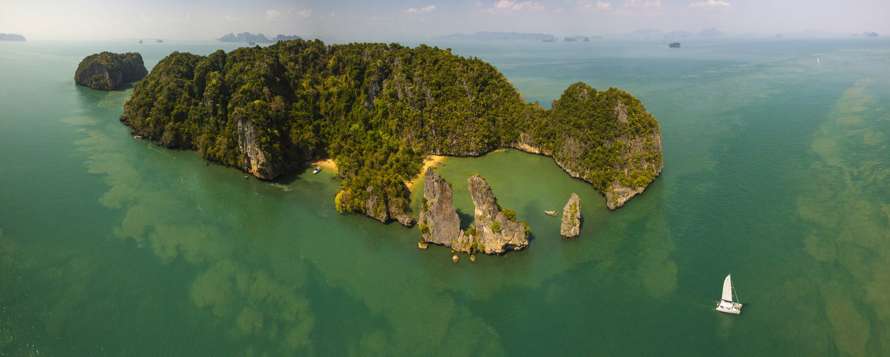 sea, water, rock formation, rock - object, scenics, nature, tranquility, beauty in nature, tranquil scene, idyllic, high angle view, physical geography, no people, waterfront, cliff, nautical vessel, sky, day, outdoors