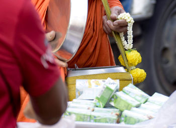 Midsection of man and woman at market stall