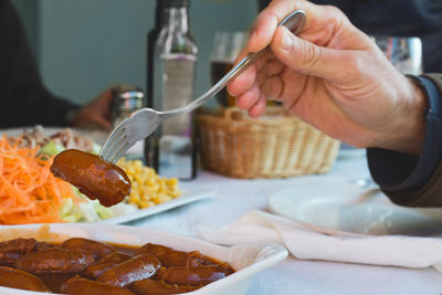 Close-up of man eating meal served in plate