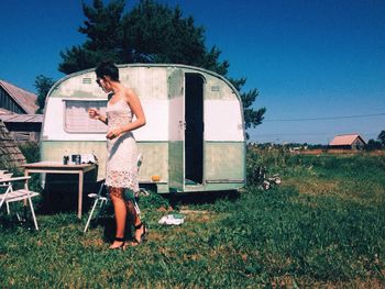 Rear view of woman standing on grass