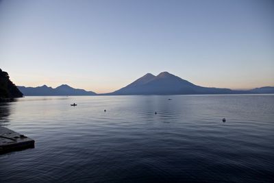 Scenic view of sea against clear sky during sunset