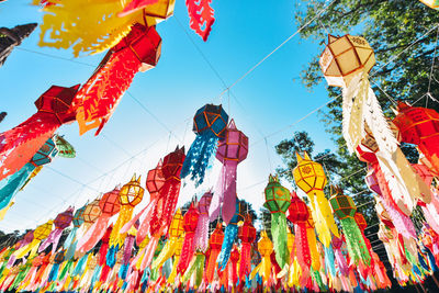 Low angle view of lanterns hanging against sky