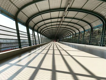 Low angle view of minimal skywalk with shadows and lights giving contrast 