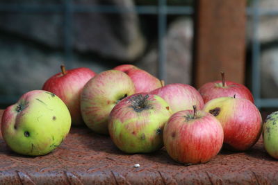 Close-up of rotten apples on rusty steps