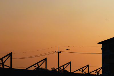 Silhouette of building against sky during sunset