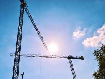 Low angle view of crane against sky