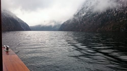 Scenic view of lake by mountains against sky