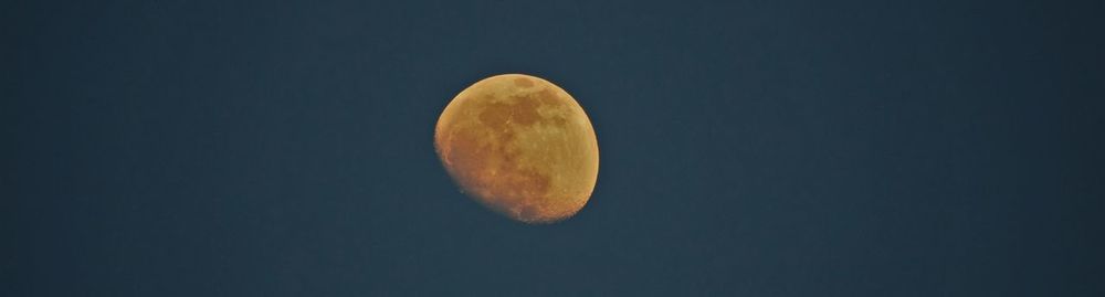 Low angle view of moon against sky at night