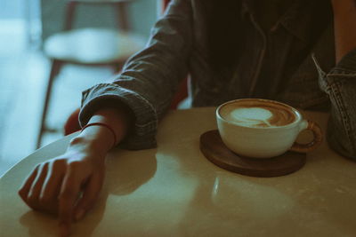 Close-up of woman holding coffee cup