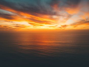 Scenic view of sea against romantic sky at sunset