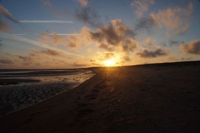 Scenic view of beach against sky during sunset