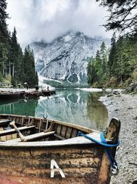 Scenic view of lake and mountains against cloudy sky