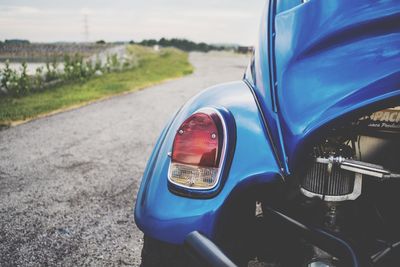 Close-up of car on road