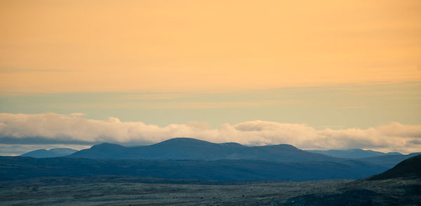 Scenic view of mountains against sky during sunset