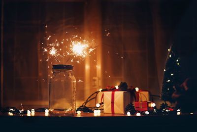 Sparklers in jar on table during christmas