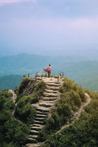 Rear view of person on sea against sky