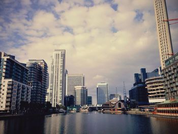 City skyline against cloudy sky