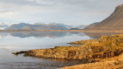 Scenic view of lake and mountains against sky