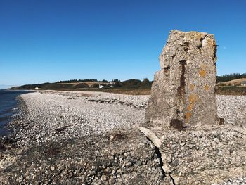 Stone wall against clear blue sky