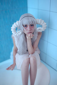 Portrait of young woman in bathtub