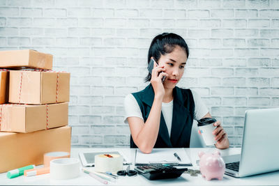 Mid adult woman using mobile phone
