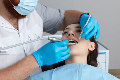 Portrait of doctor examining patient in hospital
