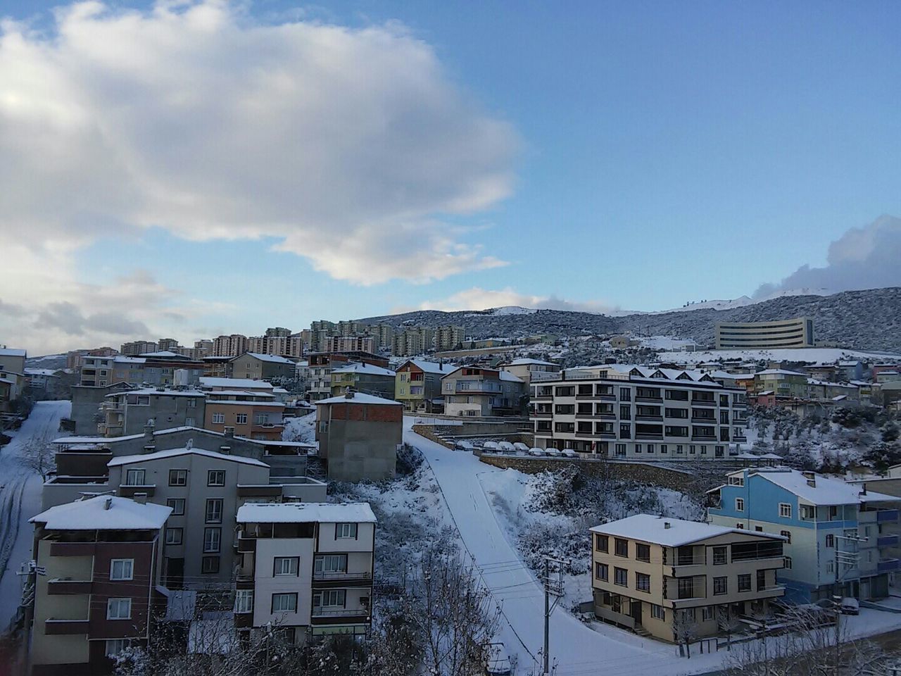 building exterior, architecture, built structure, residential building, residential structure, sky, snow, city, cold temperature, house, winter, residential district, tree, blue, cityscape, high angle view, day, season, building, cloud - sky