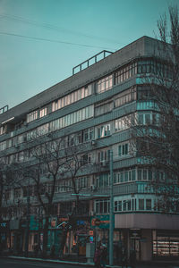 Low angle view of modern building against blue sky