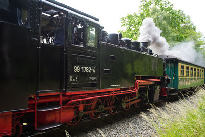 Train on railroad track against sky