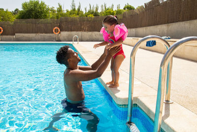 Rear view of woman in swimming pool