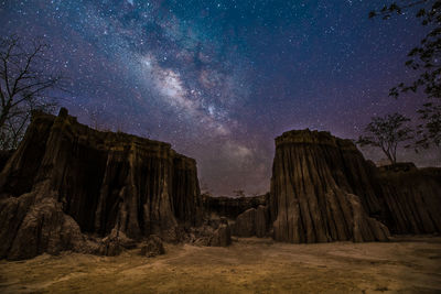 Rock formations against sky at night