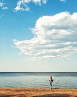 Full length of man on beach against sky