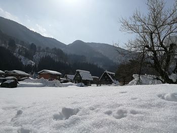 Snow covered landscape against sky