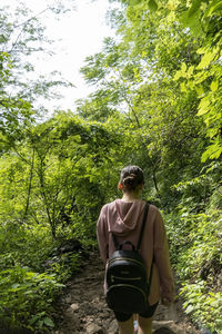 Young woman descending in the ravine, vegetation and trees, huentitan ravine guadalajara, mexico