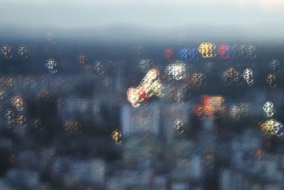 Close-up of illuminated cityscape against sky