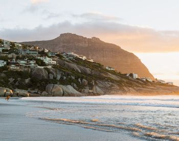 Scenic view of sea and mountains against sky