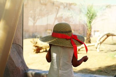 Rear view of girl with straw hat