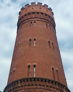 Low angle view of tower against cloudy sky