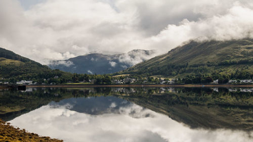 Scenic view of lake and mountains against sky