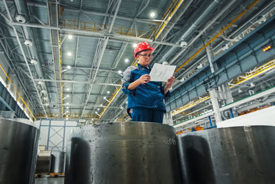 Low angle view of man working in factory