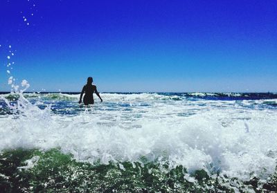 People surfing in sea