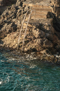 High angle view of rocks by sea