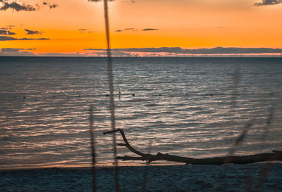 Scenic view of sea against orange sky