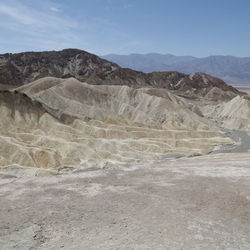 View of desert against cloudy sky