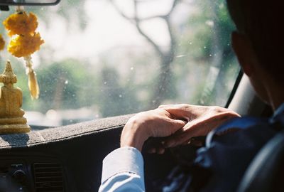 Close-up of hands holding window