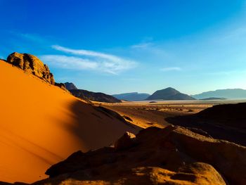 Scenic view of mountains against blue sky