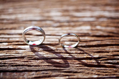 Close-up of wedding rings on wooden table